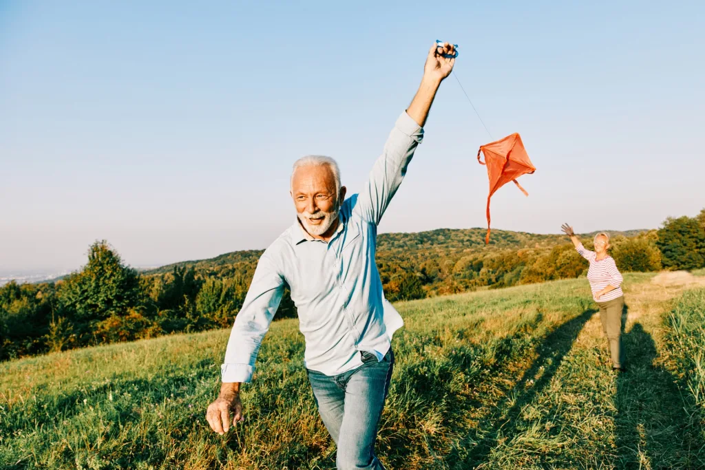 mature couple flying kites